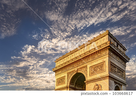 Arc de Triomphe (against the background of sky with clouds), Paris, France. The walls of the arch are engraved with the names of 128 battles and names of 660 French military leaders (in French) 103668617