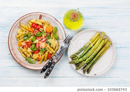 Italian pasta adorned with fresh tomatoes and aromatic basil Italian pasta adorned with fresh tomatoes and aromatic basil 103668743