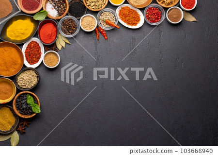 Various spices in bowls on stone table 103668940