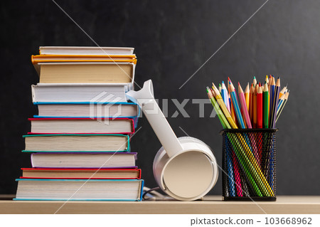 Stack of colorful books, pencils and headphones Stack of colorful books, pencils and headphones 103668962