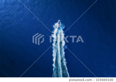 Vacation and leisure. Aerial view on fast boat on blue Mediterranean sea at sunny day. 103669100