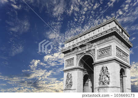 Arc de Triomphe (against the background of sky with clouds), Paris, France. The walls of the arch are engraved with the names of 128 battles and names of 660 French military leaders (in French) Arc de Triomphe (against the background of sky with clouds), Paris, France. The walls of the arch are engraved with the names of 128 battles and names of 660 French military leaders (in French) 103669173