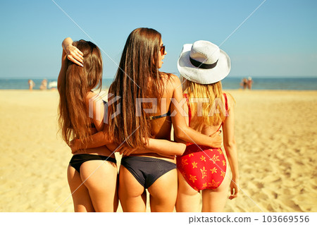 Three beautiful young girls on the beach. Excellent figures .enjoy summer time. Fun at the beach. Three beautiful young girls on the beach. Excellent figures .enjoy summer time. Fun at the beach. 103669556