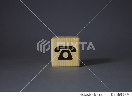 Telephone sign symbol. Telephone sign on wooden cubes. Beautiful grey background. Business and Phone concept. Copy space. 103669989