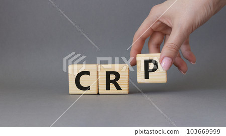 CRP - C-Reactive Protein Test symbol. Wooden cubes with word CRP. Doctor hand. Beautiful grey background. Medical and C-Reactive Protein Test concept. Copy space. CRP - C-Reactive Protein Test symbol. Wooden cubes with word CRP. Doctor hand. Beautiful grey background. Medical and C-Reactive Protein Test concept. Copy space. 103669999