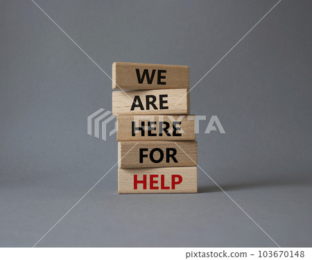 We are here to help symbol. Concept words we are here to help on wooden blocks. Beautiful grey background. Business and we are here to help concept. Copy space. 103670148