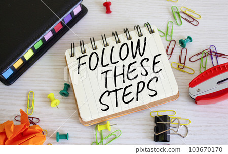 Follow these steps symbol. Concept words Follow these steps on white notebook. Beautiful wooden background. Business and Follow these steps concept. Copy space. Follow these steps symbol. Concept words Follow these steps on white notebook. Beautiful wooden background. Business and Follow these steps concept. Copy space. 103670170