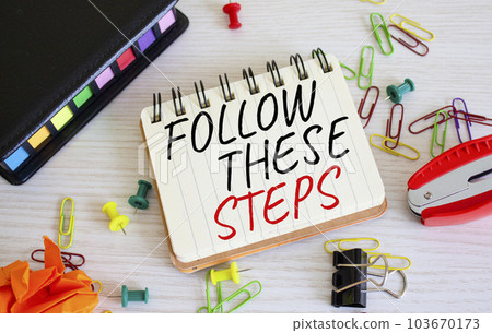 Follow these steps symbol. Concept words Follow these steps on white notebook. Beautiful wooden background. Business and Follow these steps concept. Copy space. Follow these steps symbol. Concept words Follow these steps on white notebook. Beautiful wooden background. Business and Follow these steps concept. Copy space. 103670173