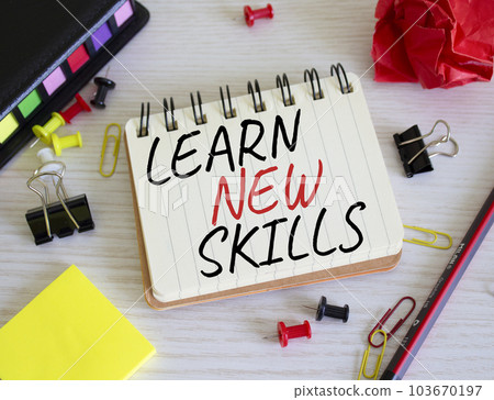 Learn new skills symbol. Concept words Learn new skills on white notebook. Beautiful wooden background. Business and Learn new skills concept. Copy space. 103670197