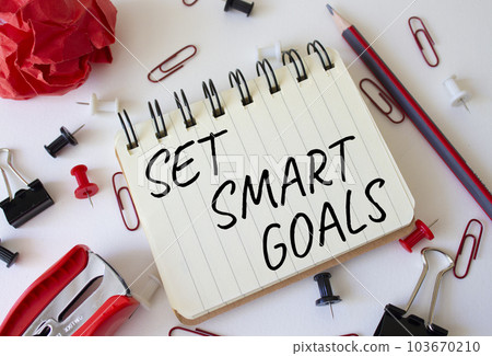 Set smart goals symbol. Concept words Set smart goals on white notebook. Beautiful wooden background. Business and Set smart goals concept. Copy space. Set smart goals symbol. Concept words Set smart goals on white notebook. Beautiful wooden background. Business and Set smart goals concept. Copy space. 103670210