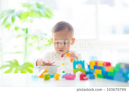 Baby boy playing with toy Baby boy playing with toy 103670799