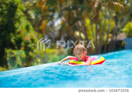 Child in swimming pool on toy ring. Kids swim. Child in swimming pool on toy ring. Kids swim. 103671056