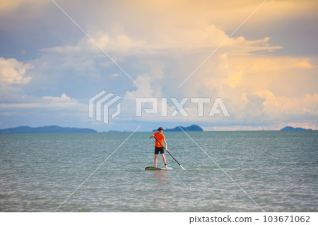 Man on stand up paddle. Water and beach sport 103671062