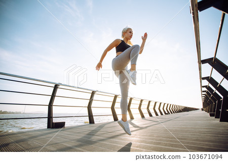 Fitness woman doing sports exercises at the beach pier. Healthy lifestyle. Sport, Active life. 103671094