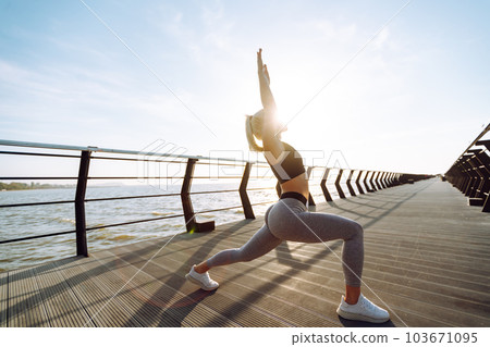Fitness woman doing sports exercises at the beach pier. Healthy lifestyle. Sport, Active life. 103671095