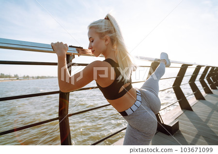 Fitness woman doing sports exercises at the beach pier. Healthy lifestyle. Sport, Active life. 103671099