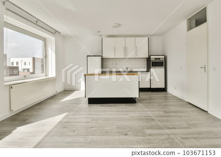 an empty kitchen and dining area in a house with white walls, wood flooring and large windows looking out onto the street an empty kitchen and dining area in a house with white walls, wood flooring and large windows looking out onto the street 103671153