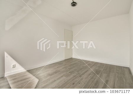 an empty room with white walls and wood flooring the room is clean and ready to be used for storage an empty room with white walls and wood flooring the room is clean and ready to be used for storage 103671177