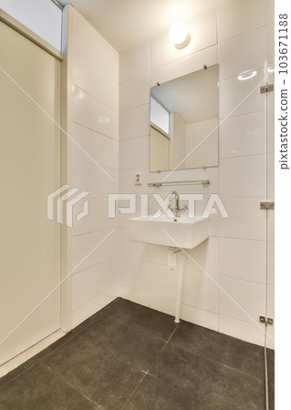 a bathroom with a sink and mirror on the wall next to an open door that leads to a walk - in shower a bathroom with a sink and mirror on the wall next to an open door that leads to a walk - in shower 103671188