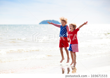 Kids with American flag on beach. 4th of July. 103671533