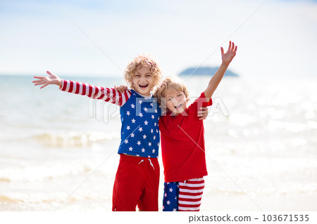 Kids with American flag on beach. 4th of July. Kids with American flag on beach. 4th of July. 103671535