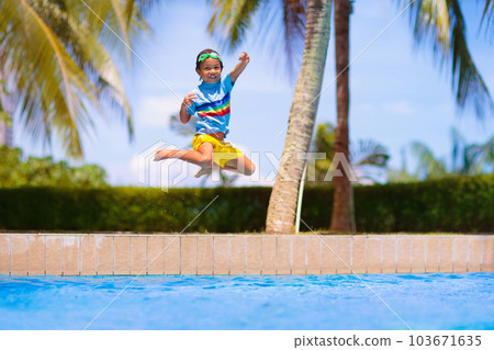 Kids jump into swimming pool. Summer water fun. 103671635
