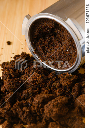 Spent or used coffee grounds with portafilter. Spent or used coffee grounds with portafilter. 103671838