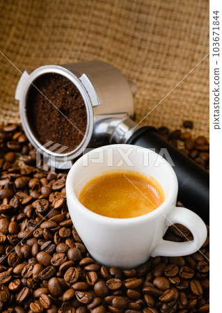 Spent or used coffee grounds with holder and a cup of freshly brewed coffee Spent or used coffee grounds with holder and a cup of freshly brewed coffee 103671844
