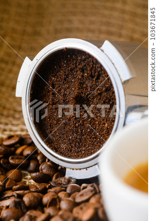 Spent or used coffee grounds with holder and a cup of freshly brewed coffee 103671845