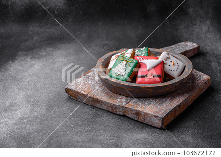 Beautiful colored Christmas gingerbread cookies for the design and decoration Beautiful colored Christmas gingerbread cookies for the design and decoration 103672172
