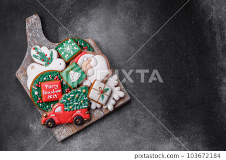 Beautiful colored Christmas gingerbread cookies for the design and decoration Beautiful colored Christmas gingerbread cookies for the design and decoration 103672184
