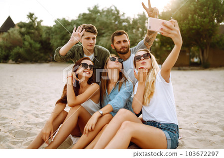Selfie time. Young friends enjoy summer party together at the beach. Friendship and lifestyle concepts. 103672297