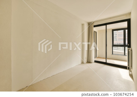 an empty living room with white walls and black trim around the window panoray, new york, ny an empty living room with white walls and black trim around the window panoray, new york, ny 103674254
