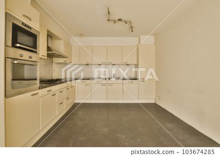 an empty kitchen with white cabinets and black counter tops on the floor in this photo is taken from the inside 103674285