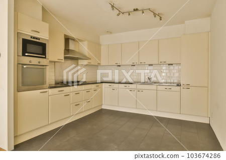 a kitchen area with white cabinets and black counter tops on the floor in this photo is taken from the inside 103674286