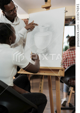 Young happy African American couple spending time together at art class, learning to draw, trying new things to strengthen relationships, family wife and husband enjoying artistic hobby together Young happy African American couple spending time together at art class, learning to draw, trying new things to strengthen relationships, family wife and husband enjoying artistic hobby together 103674841