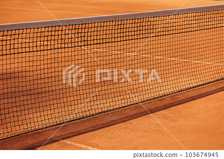 tennis net court made of red clay soil with markings for game or competition. sports and recreation 103674945