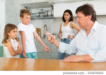Parents scold their children in kitchen at home 103676842