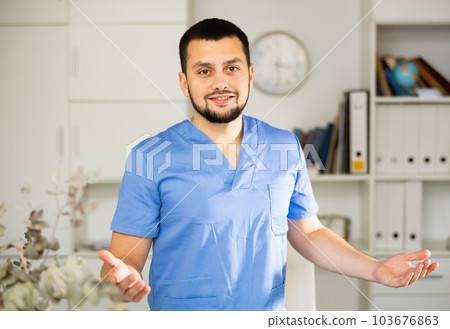 Portrait of positive man physician explaining with gestures 103676863