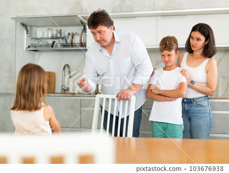Parents scold their daughter in kitchen at home 103676938