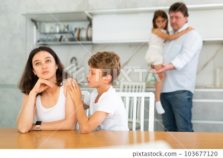 Family with two children in kitchen during quarrel Family with two children in kitchen during quarrel 103677120