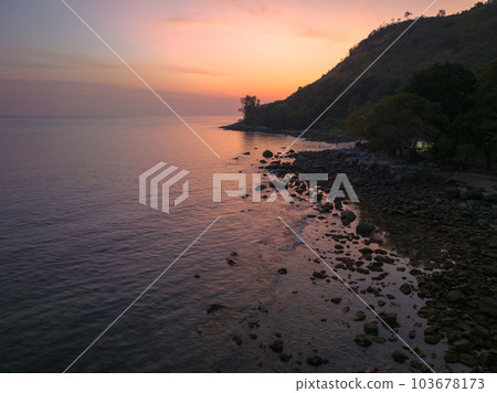 aerial view the sun going down in colorful sky impact on ocean surface The beauty of the cliff fits perfectly with the charming nature in beautiful sunset. cloud scape background 103678173