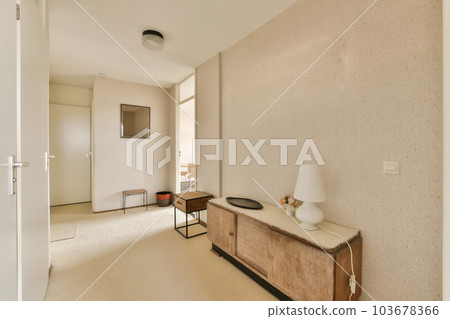 a living room with a tv on the wall and an entertainment unit in the corner between the door to the hallway a living room with a tv on the wall and an entertainment unit in the corner between the door to the hallway 103678366