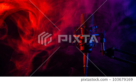 Professional microphone in red blue smoke on a black background. 103679169