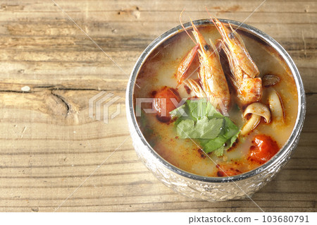 A bird's-eye view of steaming tom yum goong with tomato, coriander and shrimp A bird's-eye view of steaming tom yum goong with tomato, coriander and shrimp 103680791