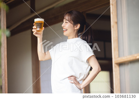 Woman drinking beer 103681130