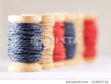 Rolls, color or fashion with string, sewing or material production against white studio background. Empty, knitting industry or texture with textiles, crocheting or weaving with embroidery or fabric Rolls, color or fashion with string, sewing or material production against white studio background. Empty, knitting industry or texture with textiles, crocheting or weaving with embroidery or fabric 103682316