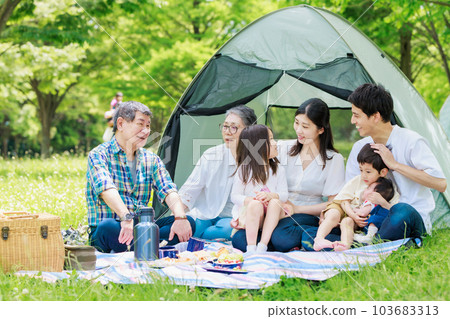 Three generation family enjoying camping 103683313