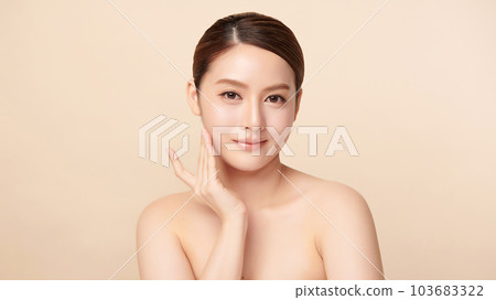 Beautiful young asian woman with clean fresh skin on beige background, Face care, Facial treatment, Cosmetology, beauty and spa, Asian women portrait. 103683322