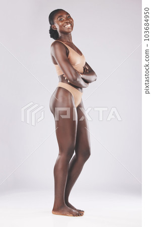 Smile, pride and black woman with arms crossed for underwear, lingerie and body against a white mockup studio background. Motivation, happy and portrait of African model with happiness for beauty 103684950